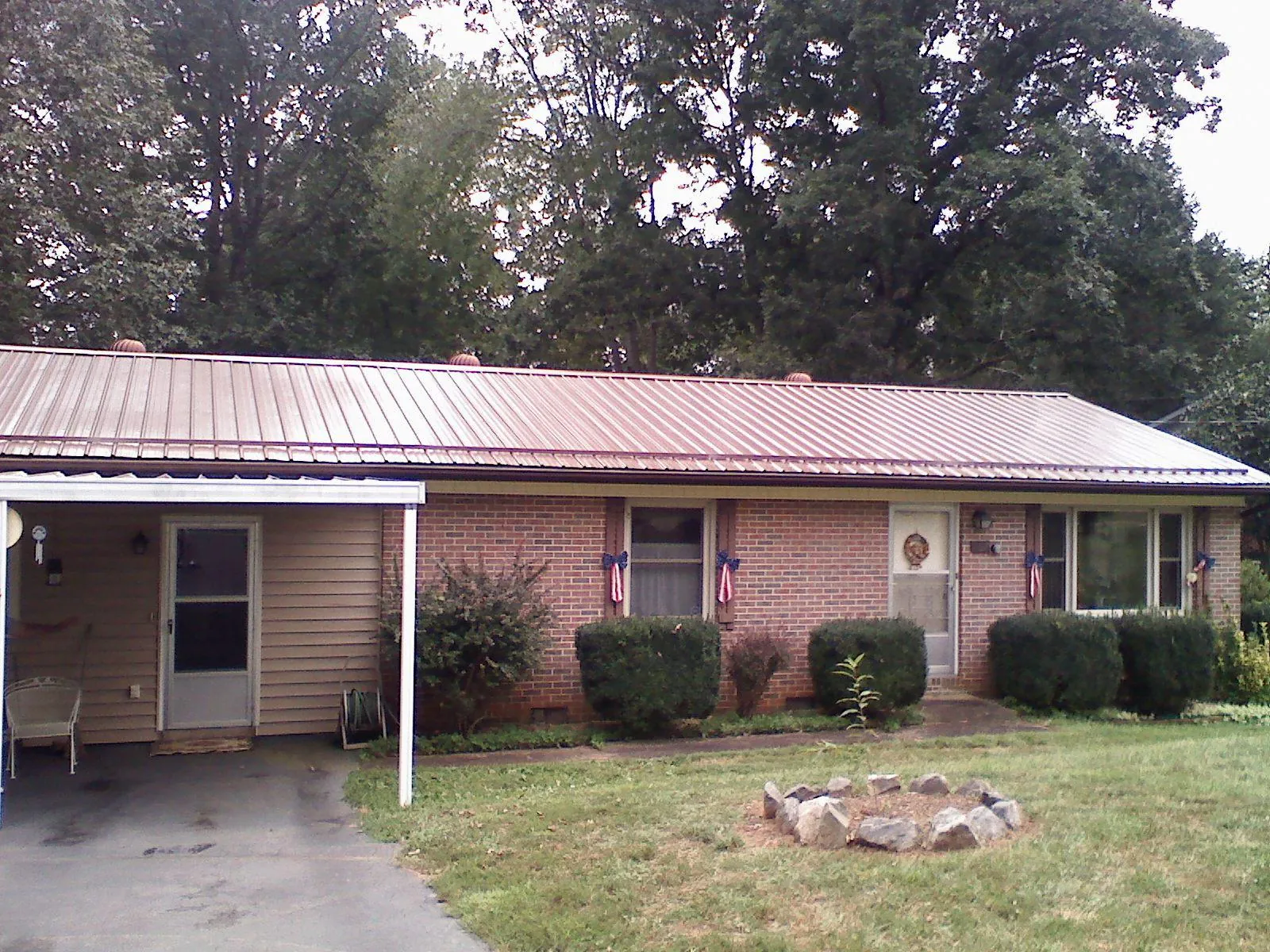 Bronze metal roof and carport on a brick ranch home — Roof Repair work by our crew in Carol Stream